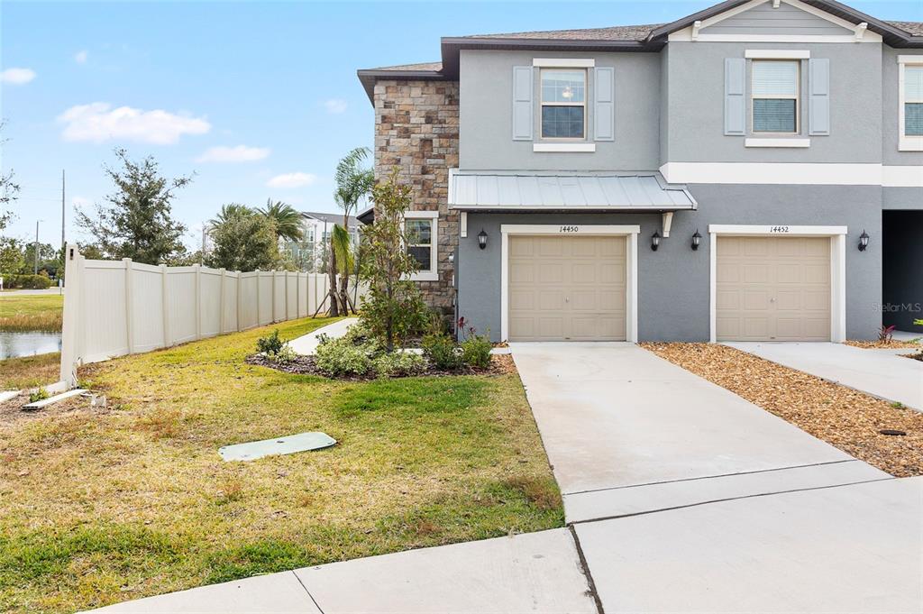 14450 Easy Goer Street Ruskin, FL 33573 - Photo 2 of 27 a front view of a house with garden