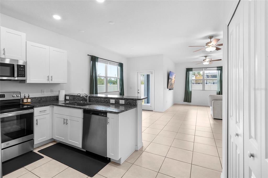 14450 Easy Goer Street Ruskin, FL 33573 - Photo 7 of 27 a kitchen with stainless steel appliances granite countertop a stove a sink and a refrigerator