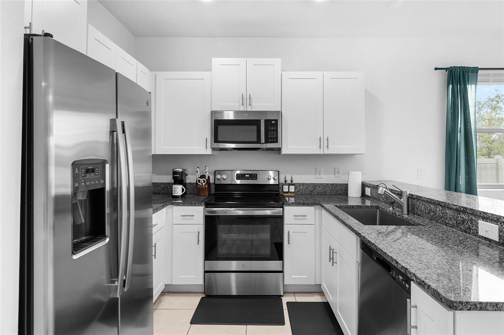 14450 Easy Goer Street Ruskin, FL 33573 - Photo 8 of 27 a kitchen with a sink stove and refrigerator