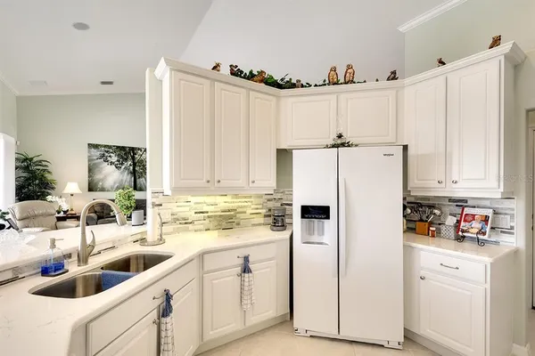 a kitchen with appliances a sink and cabinets