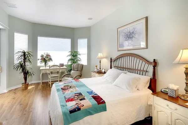 a bedroom with bed and a window