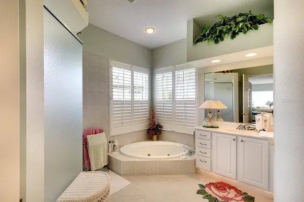 a bathroom with a toilet a sink a tub and mirror