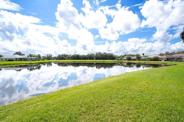 a view of a lake with houses in the background