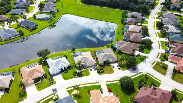 an aerial view of a house with a garden and lots of trees