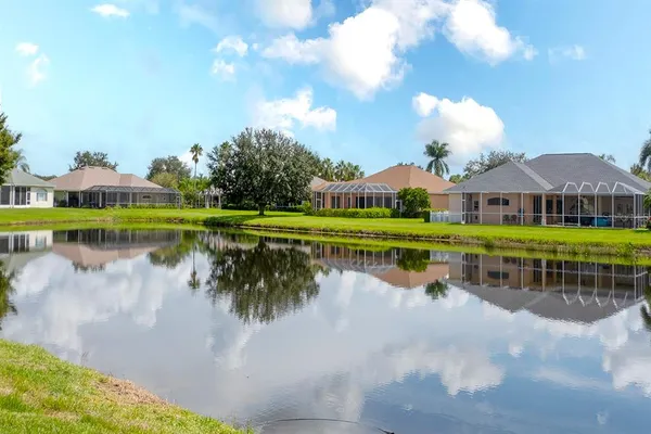 a view of a lake with a house in the background