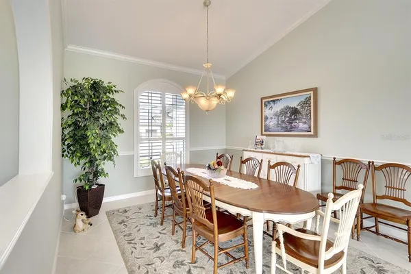 a view of a dining room with furniture and a potted plant
