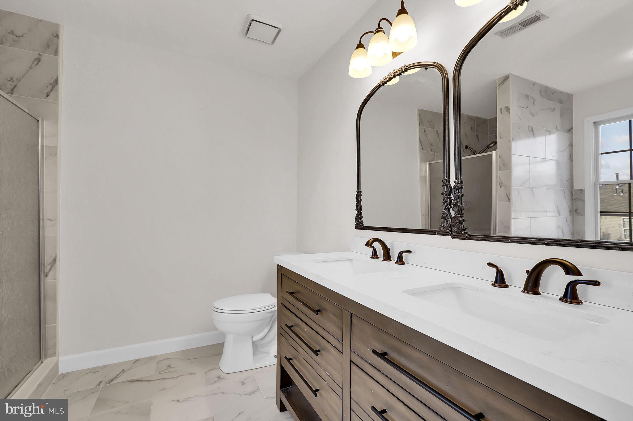 3920 Dunes Way Burtonsville, MD 20866 - Photo 22 of 33 a bathroom with a double vanity sink and a mirror
