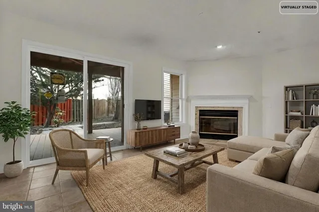 a view of an empty room with glass door and a fireplace