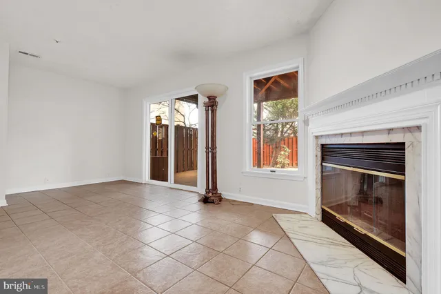 a view of an empty room with a fireplace