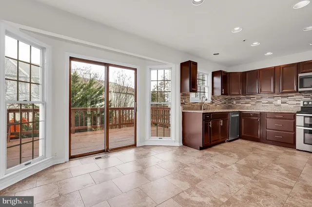 a kitchen with stainless steel appliances granite countertop a stove sink and cabinets