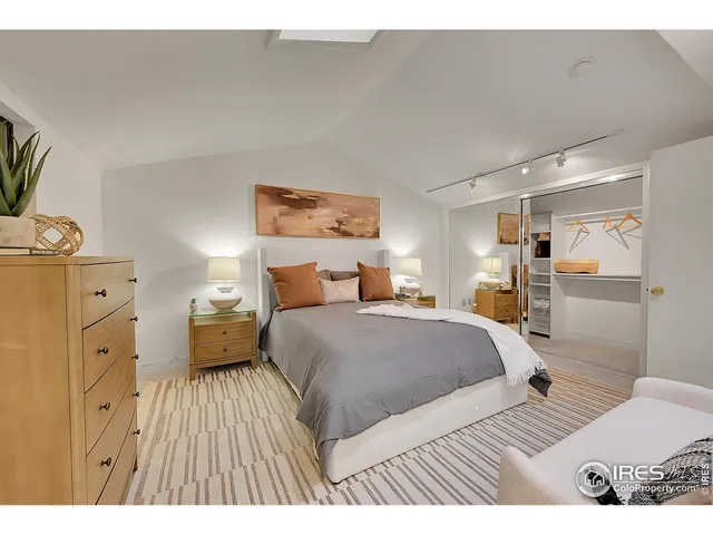 a bedroom with a large bed and a chandelier