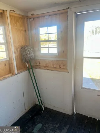 a kitchen with sink a window and cabinets