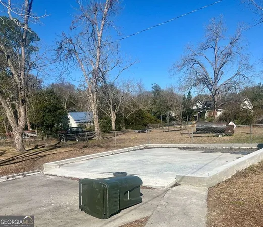 a view of yard with wooden fence