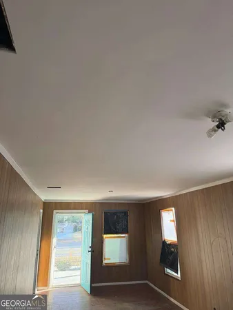 an empty room with windows and closet