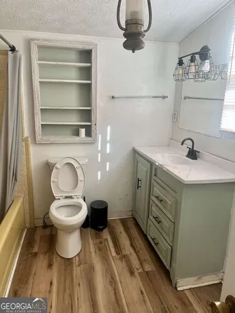 a kitchen with cabinets and wooden floor