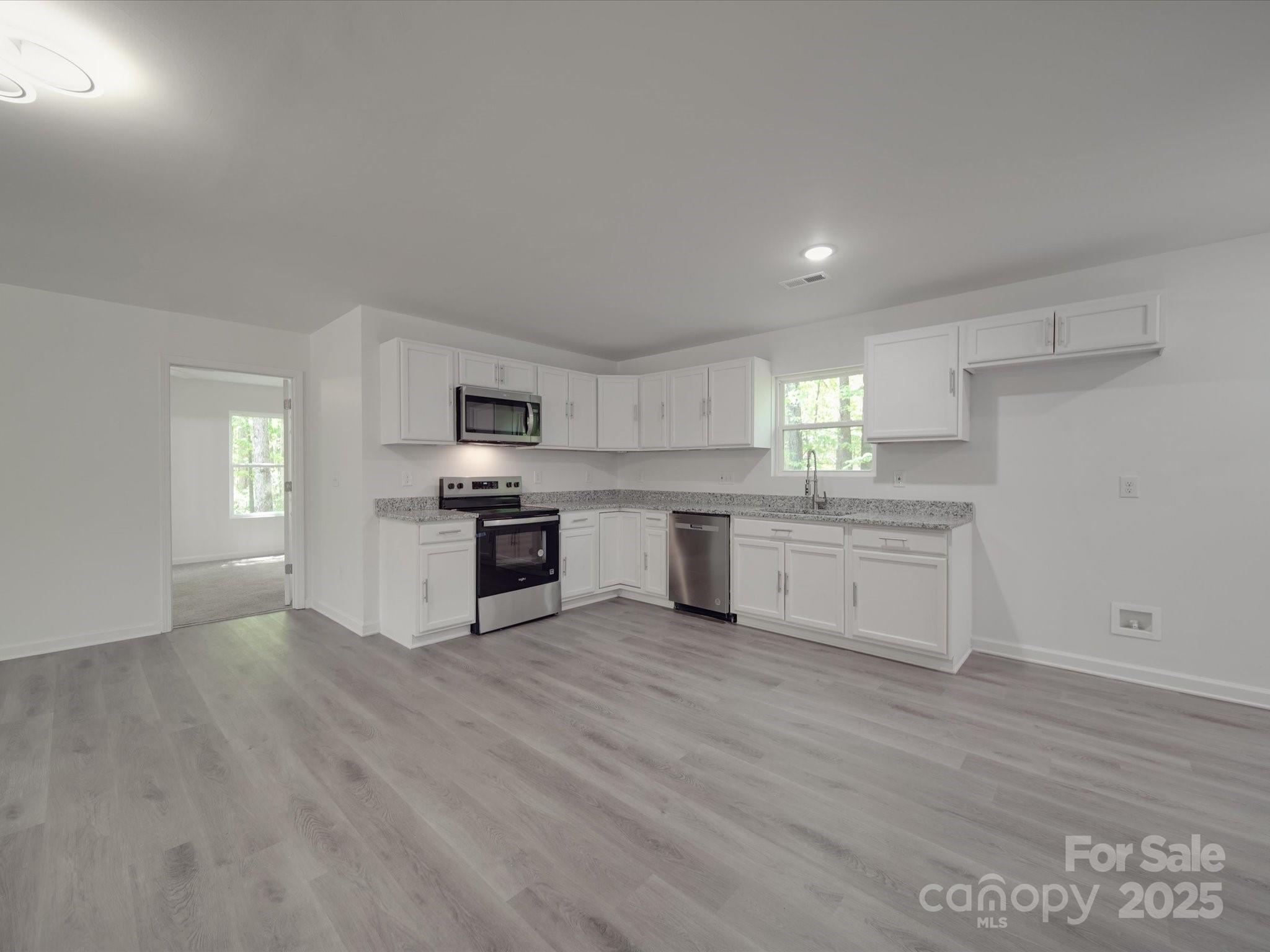1241 Pitts Road Chester, SC 29706 - Photo 8 of 41 a kitchen with granite countertop white cabinets and stainless steel appliances