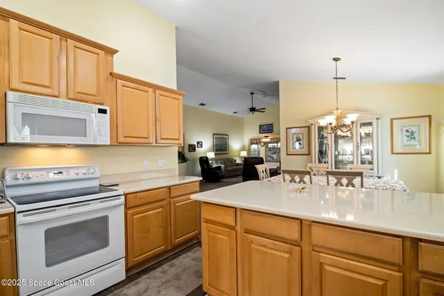 a kitchen with stainless steel appliances a sink stove and cabinets