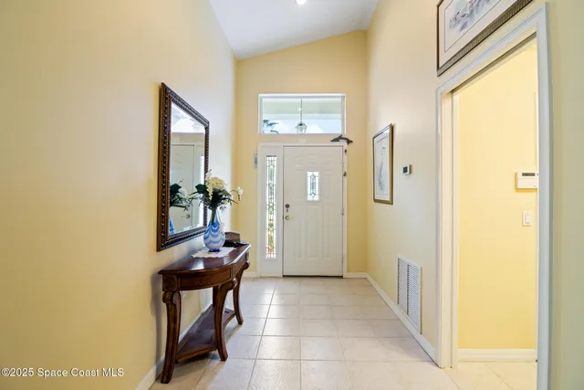 a view of a hallway with dining area and glass door