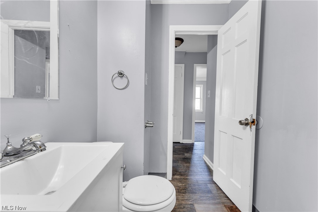 15400 Rockside Road Maple Heights, OH 44137 - Photo 18 of 31 Bathroom with vanity with extensive cabinet space, wood-type flooring, and toilet