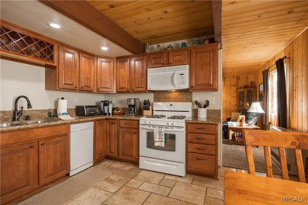 a kitchen with stainless steel appliances granite countertop a stove sink and cabinets