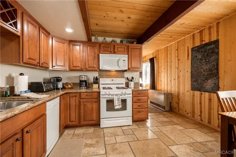 a kitchen with stainless steel appliances granite countertop a stove sink and cabinets