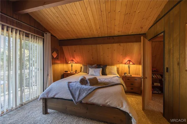 a bedroom with a bed and large window