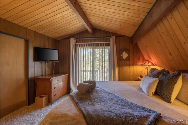 a bed sitting in a bedroom next to a window