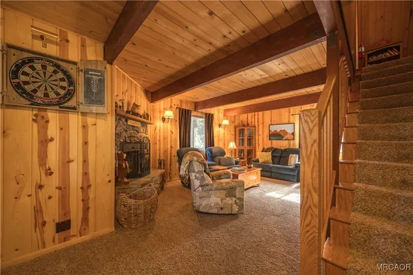 a view of a patio with table and chairs and couches with wooden floor