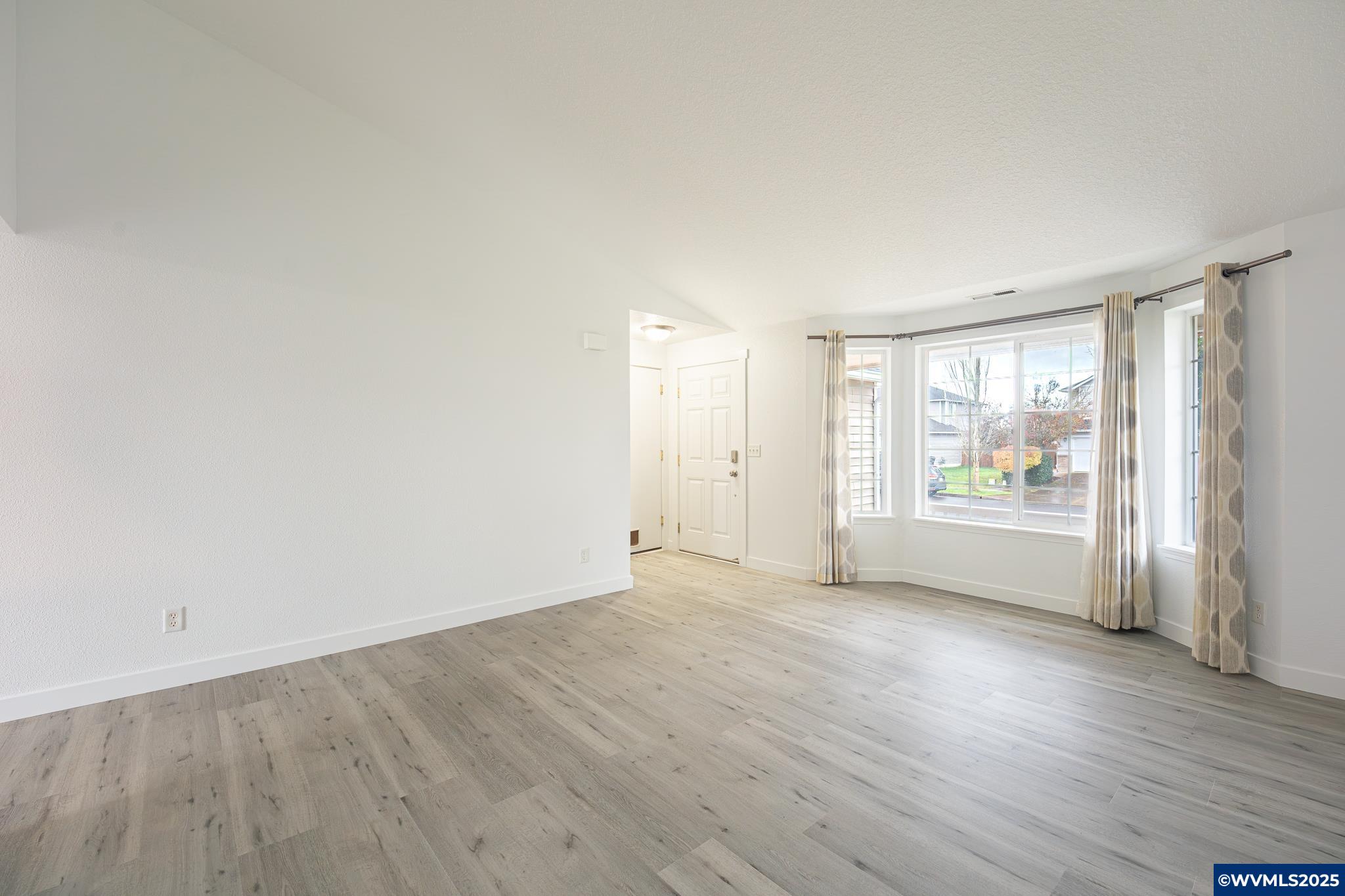 1467 South 7th Street Independence, OR 97351 - Photo 3 of 31 an empty room with wooden floor and windows