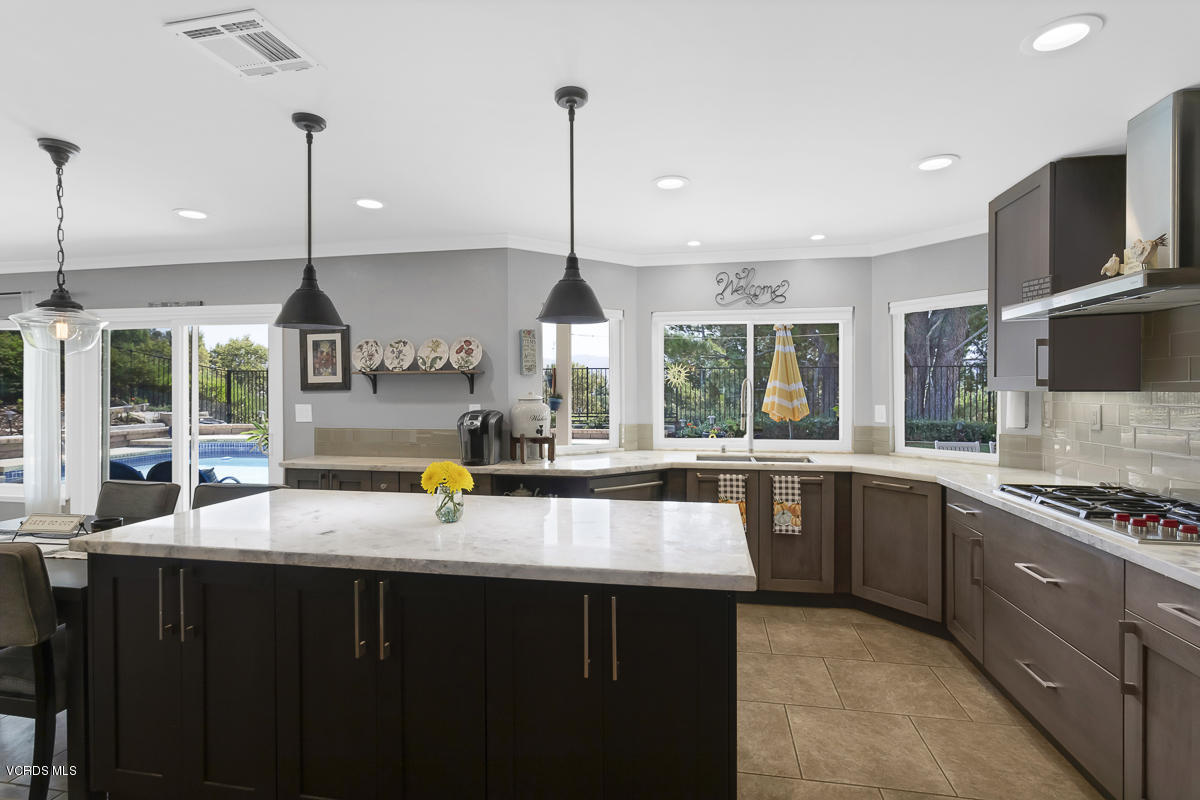 5438 Cochise Street Simi Valley, CA 93063 - Photo 13 of 35 a kitchen with stainless steel appliances granite countertop a sink a stove and wooden floor