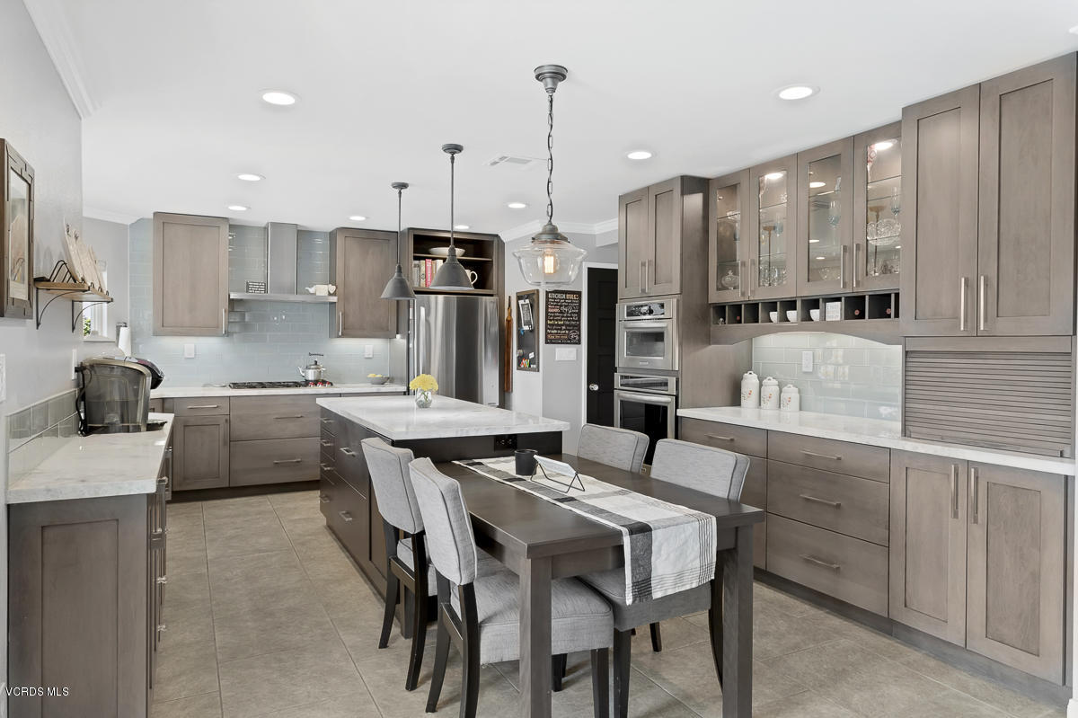 5438 Cochise Street Simi Valley, CA 93063 - Photo 14 of 35 a kitchen with stainless steel appliances kitchen island granite countertop a sink and cabinets