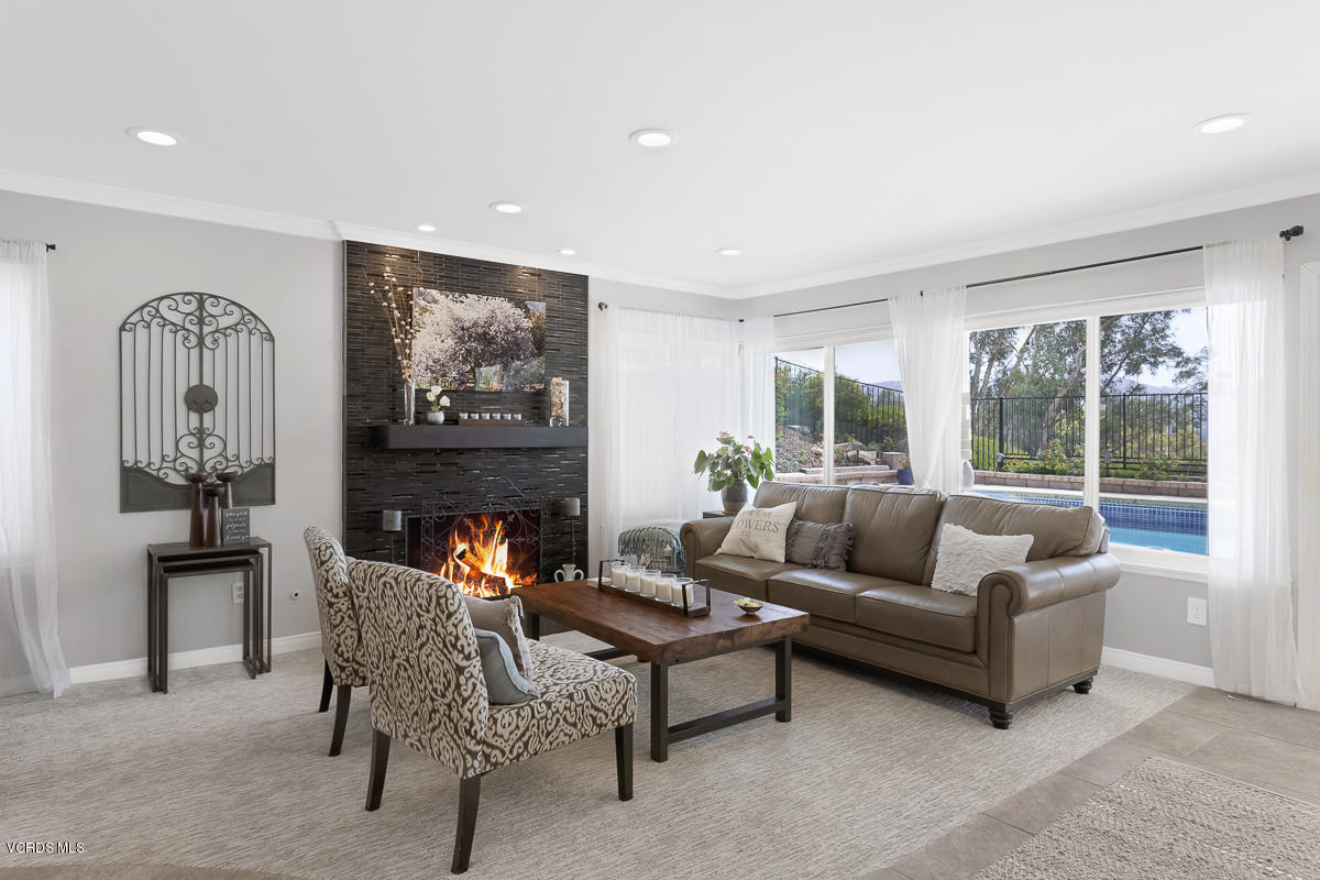 5438 Cochise Street Simi Valley, CA 93063 - Photo 18 of 35 a living room with furniture and a fireplace