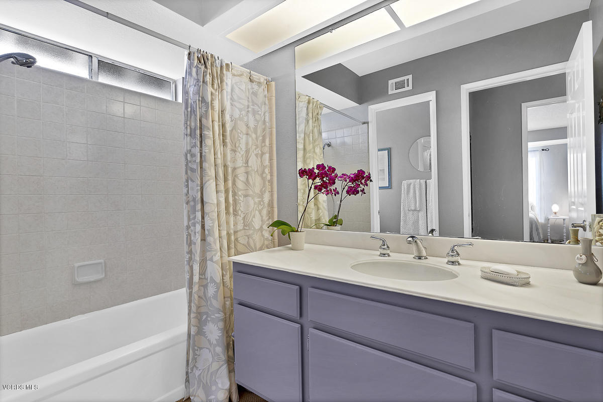 5438 Cochise Street Simi Valley, CA 93063 - Photo 24 of 35 a bathroom with a granite countertop sink mirror and a bathtub
