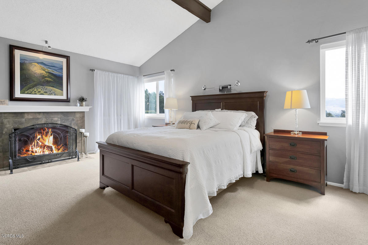 5438 Cochise Street Simi Valley, CA 93063 - Photo 25 of 35 a spacious bedroom with a bed and a fireplace