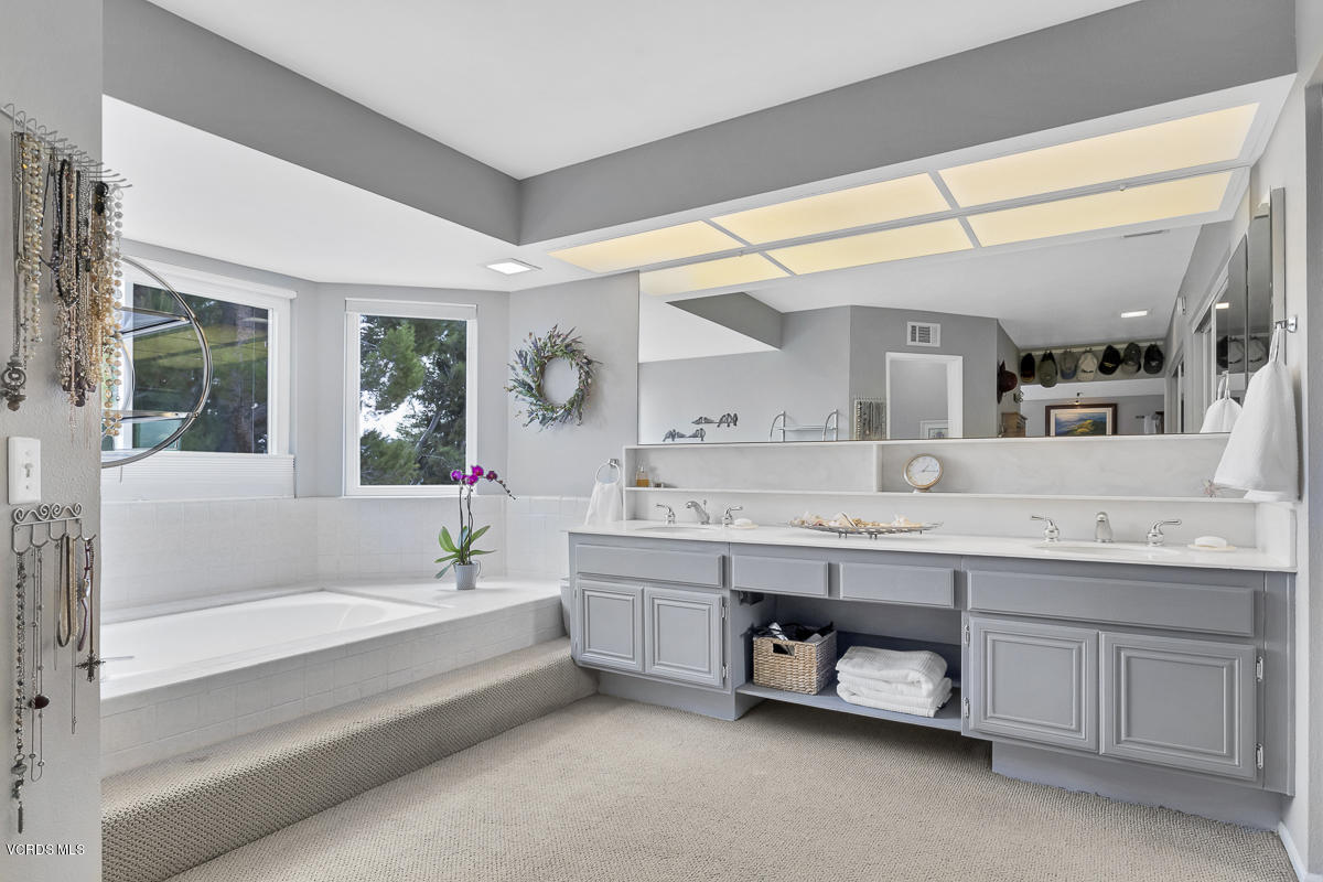 5438 Cochise Street Simi Valley, CA 93063 - Photo 27 of 35 a spacious bathroom with a tub double sink and a large mirror