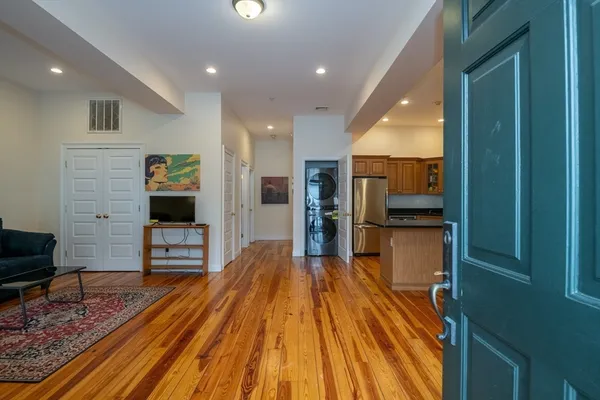 a view of kitchen with sink and refrigerator