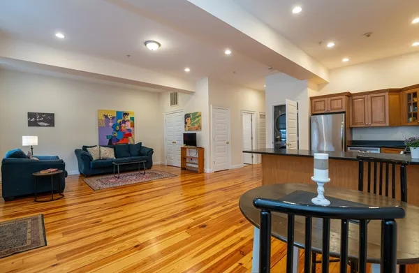 a living room with fireplace furniture and a wooden floor