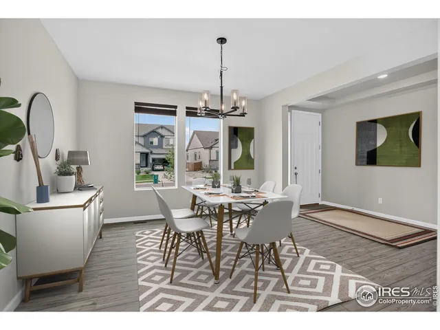 a dining room with furniture a chandelier and wooden floor