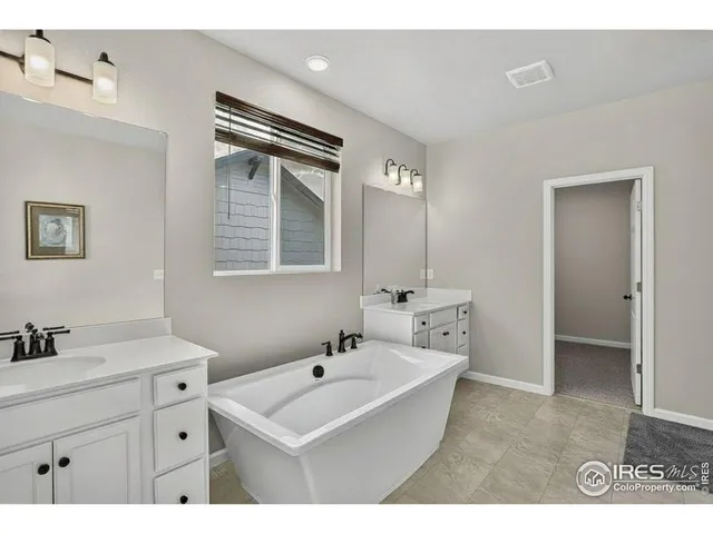 a bathroom with a sink double vanity and a mirror