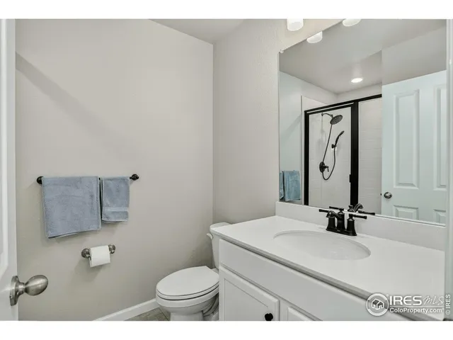 a bathroom with a sink toilet and mirror