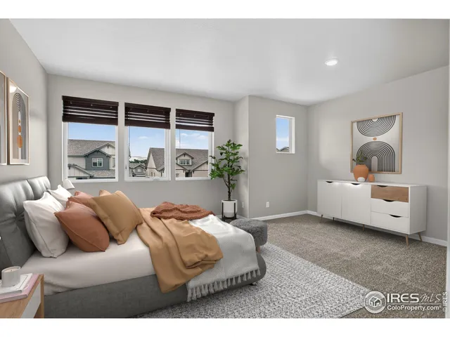 a bedroom with a bed and a large window