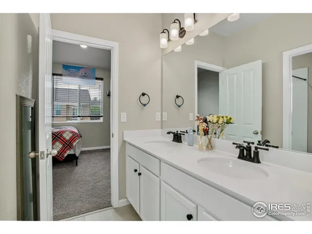 a en suite bathroom with a double vanity sink