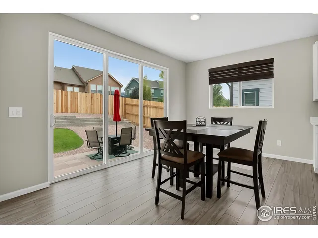 a dining room with furniture and wooden floor