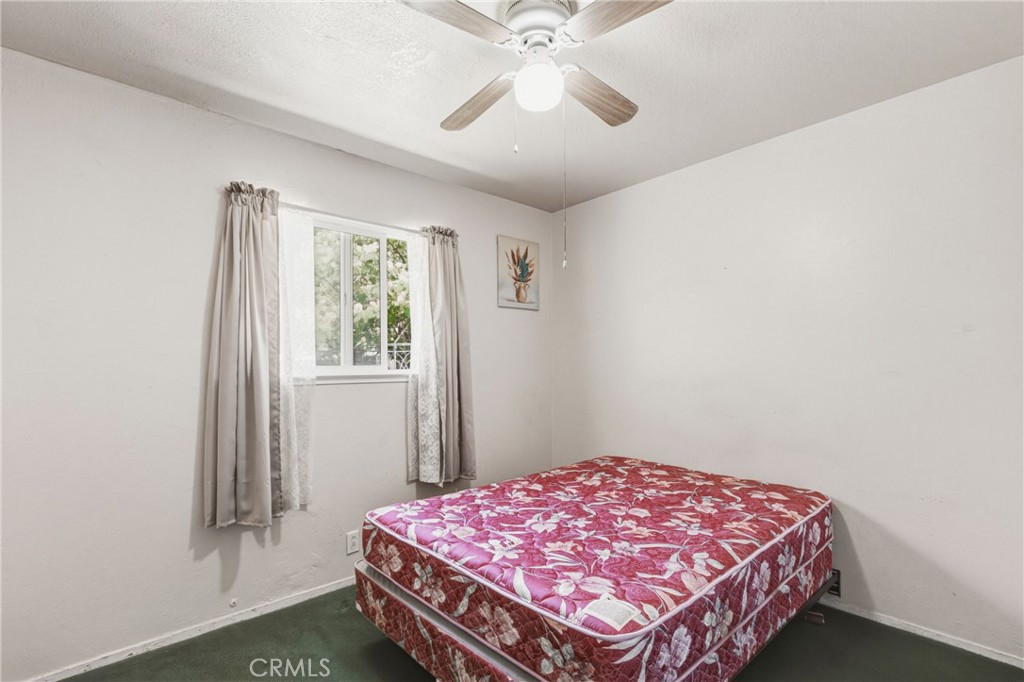 6812 Helton Street Winton, CA 95388 - Photo 18 of 24 a bedroom with a bed and a window