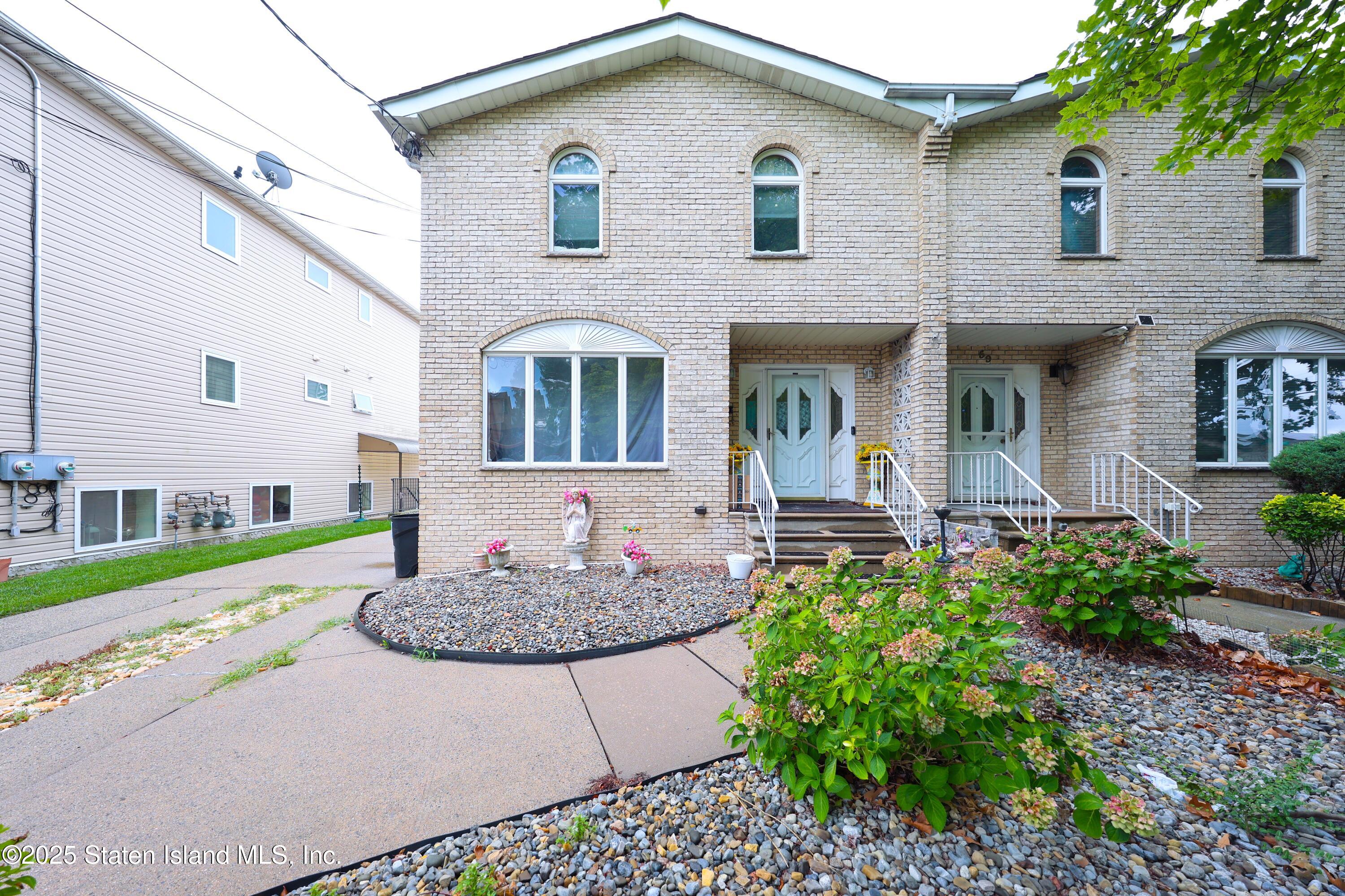 a front view of a house with garden