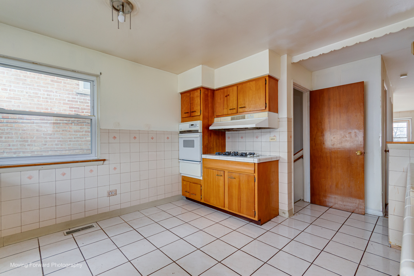 9726 S Lane Chicago, IL 60628 - Photo 19 of 27 a kitchen with stainless steel appliances a sink and a refrigerator