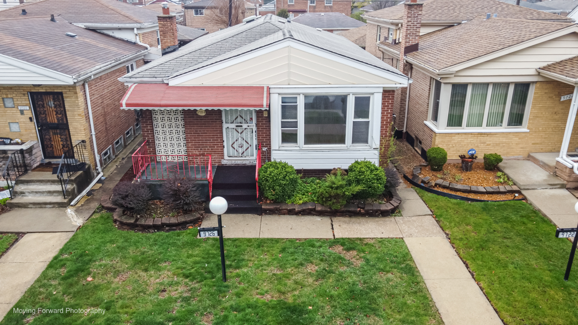 9726 S Lane Chicago, IL 60628 - Photo 2 of 27 a front view of a house with garden