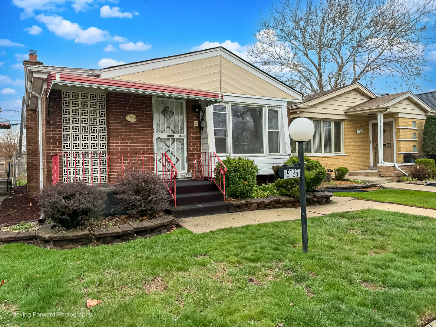9726 S Lane Chicago, IL 60628 - Photo 4 of 27 a front view of a house with a yard and porch