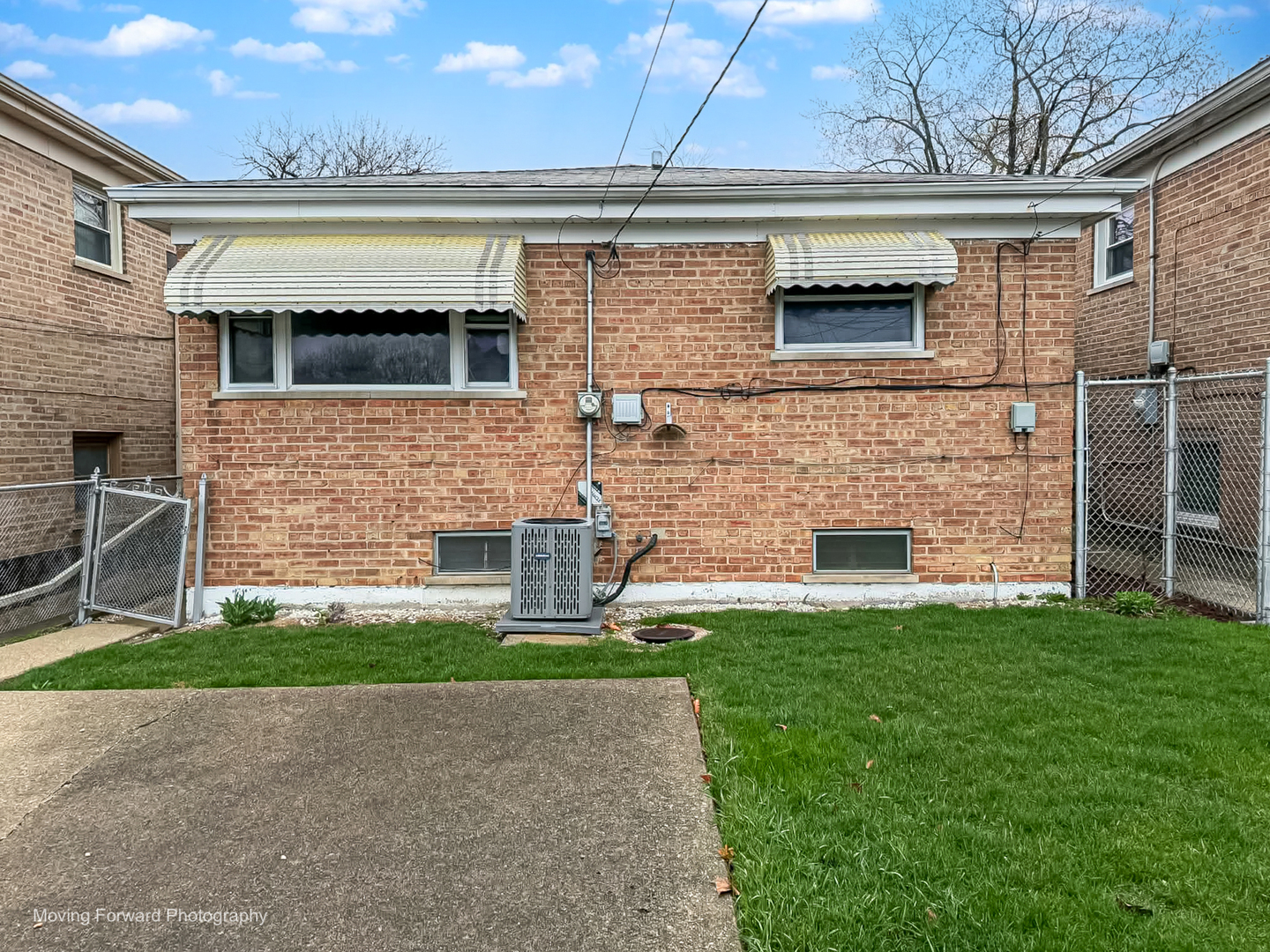 9726 S Lane Chicago, IL 60628 - Photo 6 of 27 a front view of a house with a garden and garage