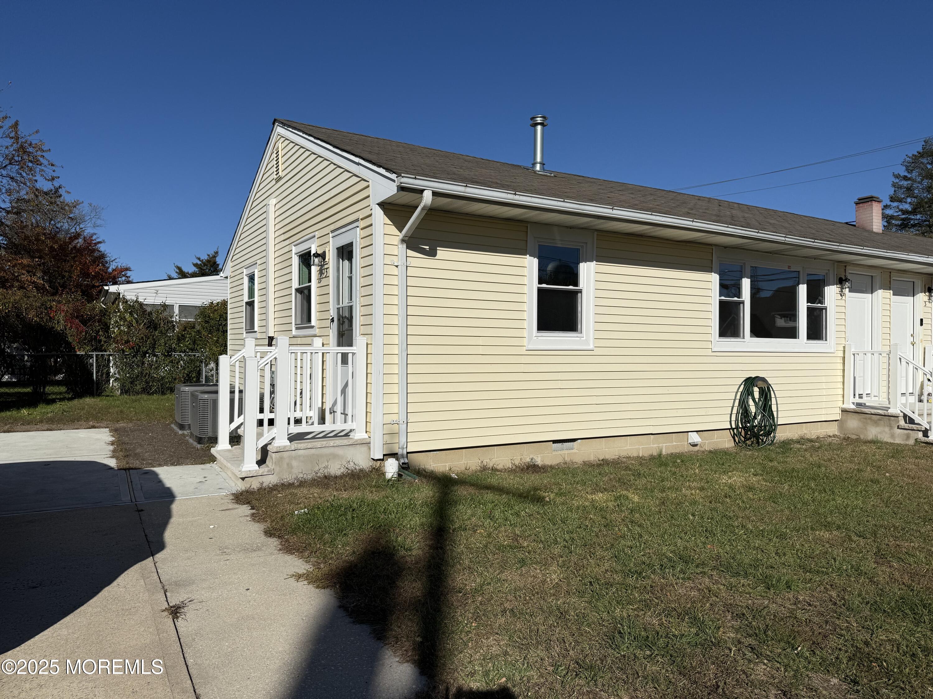 616 Ocean Gate Avenue, Unit 5 Ocean Gate, NJ 08740 - Photo 2 of 15 a front view of a house with garden